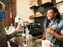黑人咖啡师对用手机付款的顾客竖起大拇指